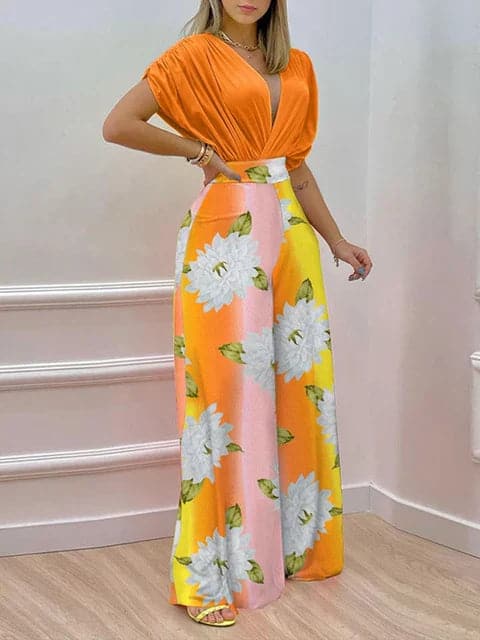 Dambyxa Jumpsuit - Djup V-ringning - Korta Ärmar - Vid Benpassform - Elegant Blommig Design