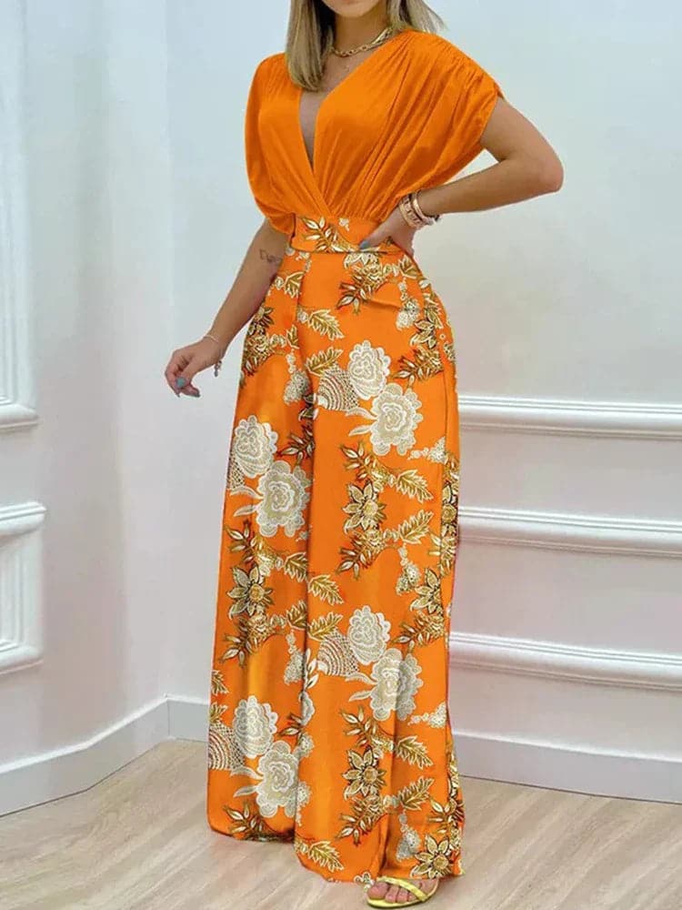 Dambyxa Jumpsuit - Djup V-ringning - Korta Ärmar - Vid Benpassform - Elegant Blommig Design