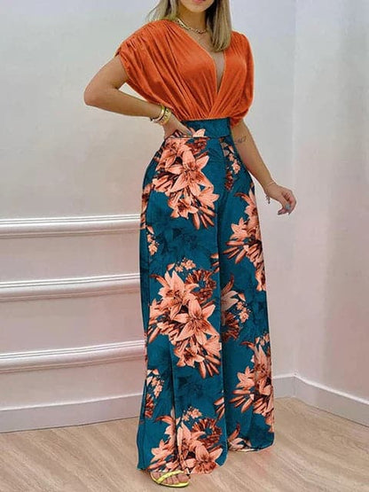 Dambyxa Jumpsuit - Djup V-ringning - Korta Ärmar - Vid Benpassform - Elegant Blommig Design