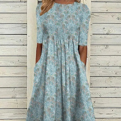 Damklänning i midimodell - Lös passform - Rund halsringning - Blommigt tryck - Ficka